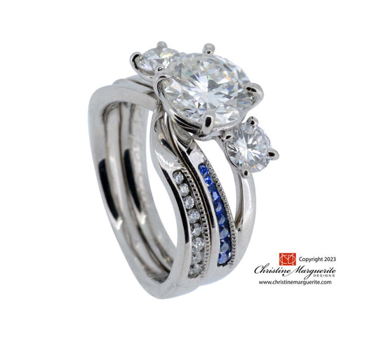 Platinum diamond and sapphire asymmetrical channel setting