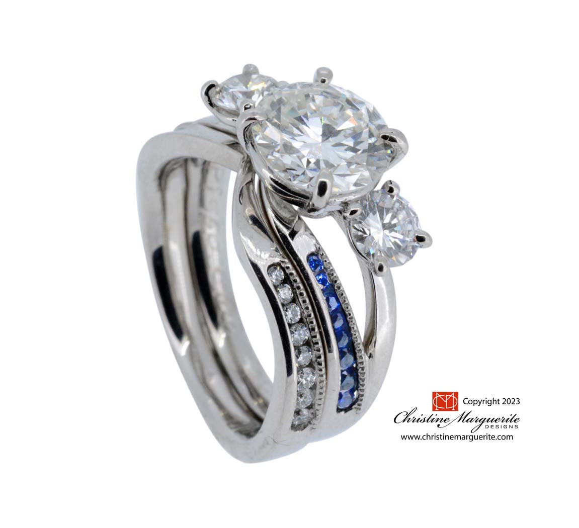 Platinum diamond and sapphire asymmetrical channel setting